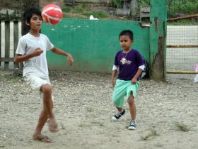 Volunteers play sports with the children in the afternoon.