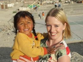 a volunteer with a child from the community school
