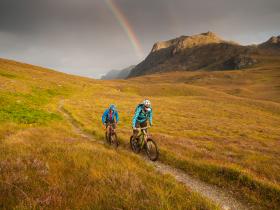 Coast-to-coast mtb tour Scotland: rainbow over trail