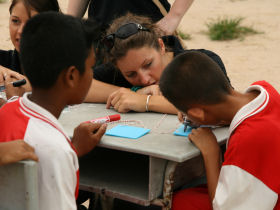 volunteeres helping children to make their name badges