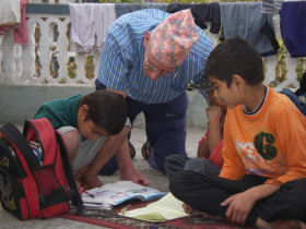a volunteer helping some children in school
