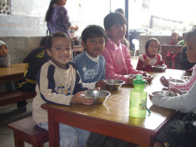 children in the orphanage enjoying lunch