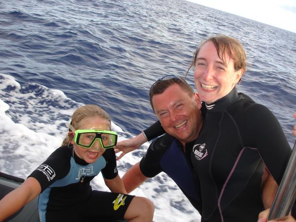 Family swimming with dolphins in the Azores