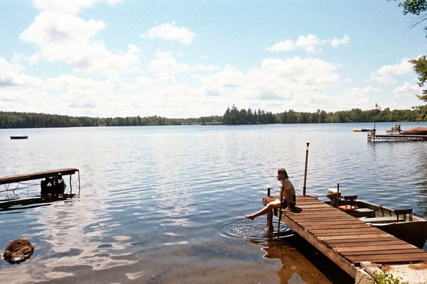 Catherine sitting on a boat jetty in Thousand Islands