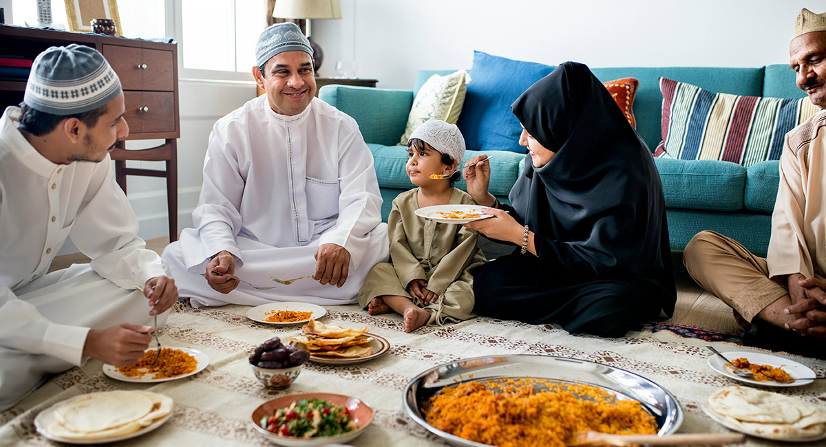 A homestay family sitting down to eat together