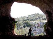Walker in cave opening, Menorca. Photo by Nick Haslam