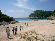 Walkers on the beach in Menorca. Photo from Audax Hotel