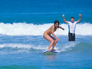 Girl surfing in Western Australia. Photo by Tourism Western Australia