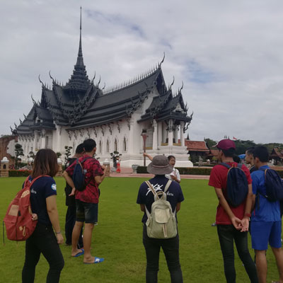 Tour group with white temple in background