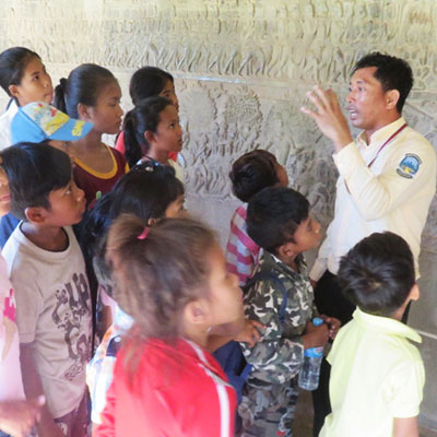 Guide showing the children wall carvings