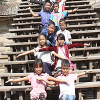 Children posing on a staircase