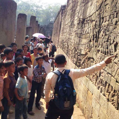 Guide explaining the wall carvings