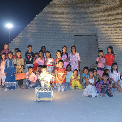 Kids pose infront of the Great Pyramid replica, Eco park, India