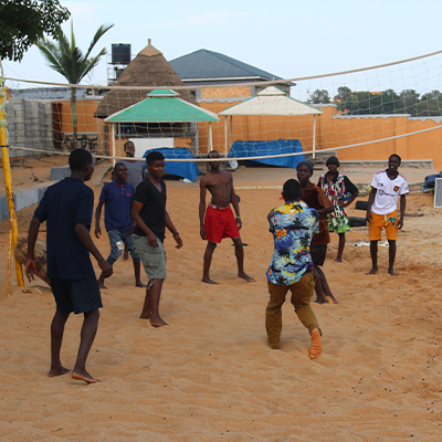 Group of kids play beach volleyball at Entebbe beach