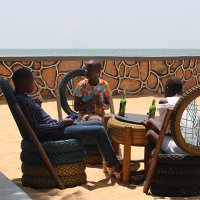 3 children share Sodas and a chat at Entebbe beach