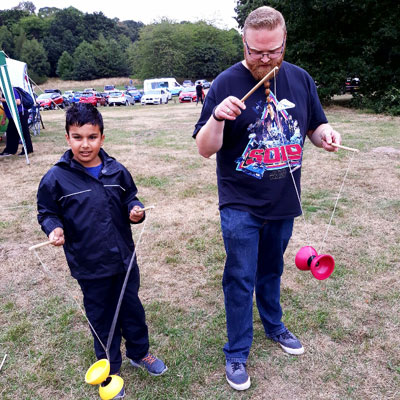 Child and adult playing with diabolo toy