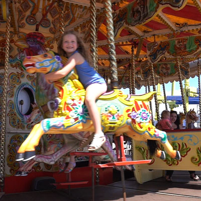 Little girl on carousel horse