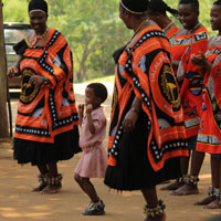 Little girl dancing with women on stage