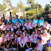 Happy children in front of large statue