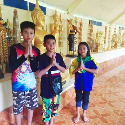 Namaste pose with golden statues