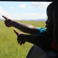 Children pointing from the van window