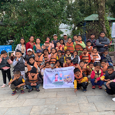 The whole group posing for a photo together with a banner