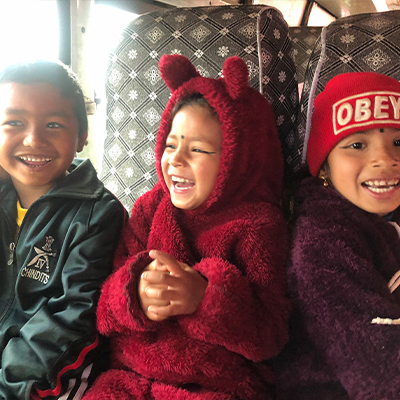 Some of the kids posing for a photo on the bus