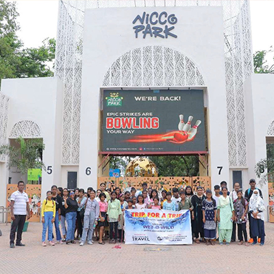 The children and staff pose for a photo outside Nicco Amusement park, India