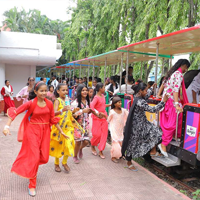 The children rush toward a train ride