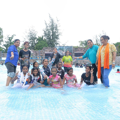 Some of the children and staff pose for a photo at Nicco amusement park, India