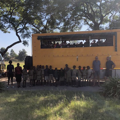 The whole groups standing by an overland truck