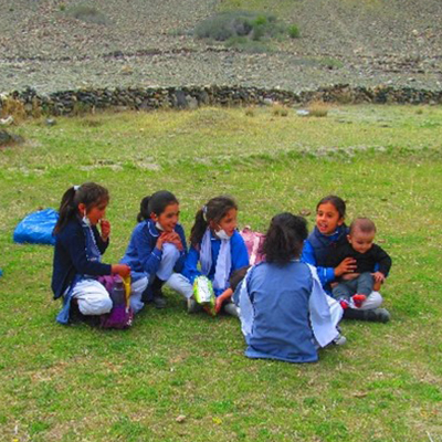 The kids sitting on the grass chatting