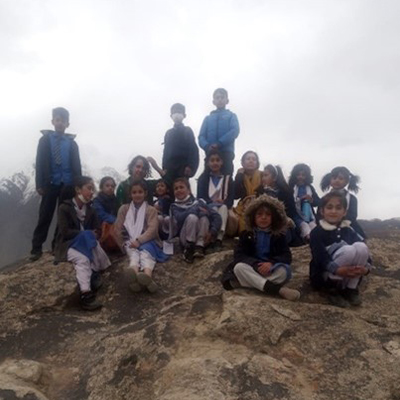 The kids pose on some rocks