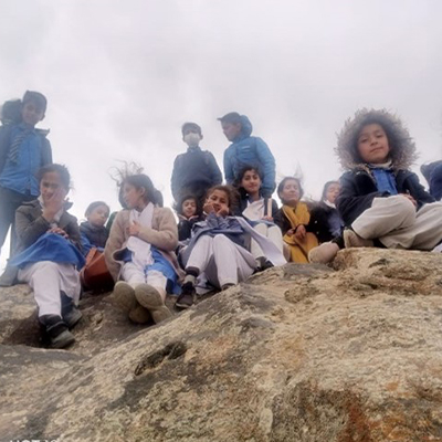 The kids posing on some rocks from a different angle