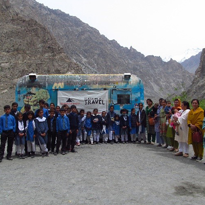 Group photo of everyone involved in the trip beside their transport