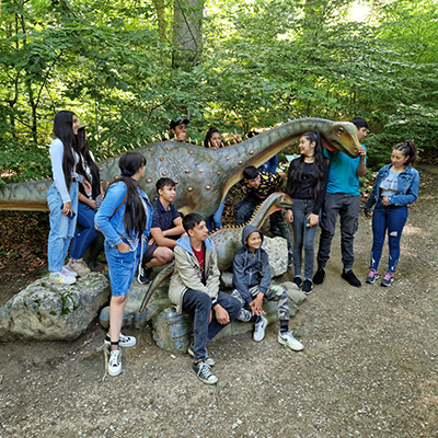 The children pose with a dinosaur