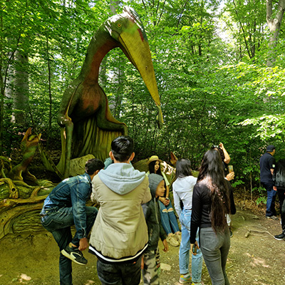 The children pose with a dinosaur