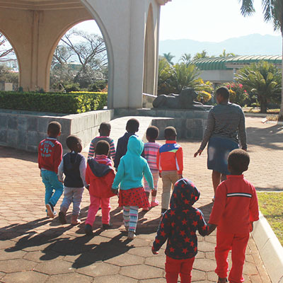Children walking to statue