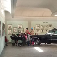 children looking at the old cars