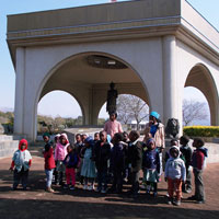 Children standing in front of a monument